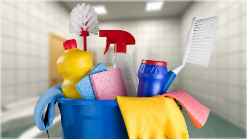 Carpet cleaning professional preparing equipment with safety precautions in NW6
